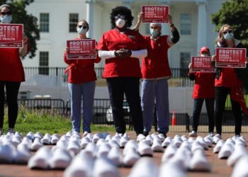 National Nurses United (NNU) display 164 white clogs shoes outside the US Capitol to honor the more than 160 nurses who have lost their lives from COVID-19 in the United States, and to demand the Senate act swiftly to protect nurses on the frontlines in Washington, DC on July 21, 2020. Photo by Olivier DOULIERY / AFP