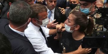 French President Emmanuel Macron, speaks with a woman as he visits the Gemayzeh neighborhood, which suffered extensive damage from an explosion on Tuesday that hit the seaport of Beirut
Image Credit: AP