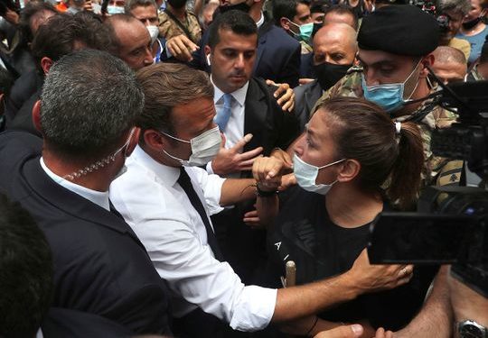 French President Emmanuel Macron, speaks with a woman as he visits the Gemayzeh neighborhood, which suffered extensive damage from an explosion on Tuesday that hit the seaport of Beirut
Image Credit: AP