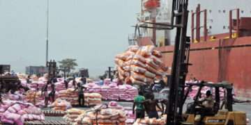 Workers unload bags of rice on January 19, 2011 at the Port of Abidjan where 80% of Ivory Coast's exports transit. EU-registered ships have been barred from dealing with Ivory Coast's main cocoa ports in line with sanctions over the nation's controversial November presidential poll. The European Union last weekend slapped sanctions on outcast incumbent leader Laurent Gbagbo and 84 of his associates, as well as 11 economic entities in the world's top cocoa producer. AFP PHOTO/ ISSOUF SANOGO (Photo credit should read ISSOUF SANOGO/AFP/Getty Images)