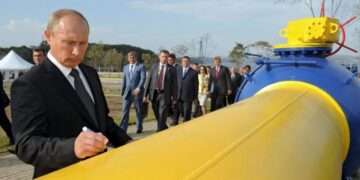 President Vladimir Putin standing by one of Russia's gas pipeline