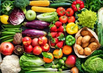 Food background with assortment of fresh healthy organic fruits and vegetables on the table