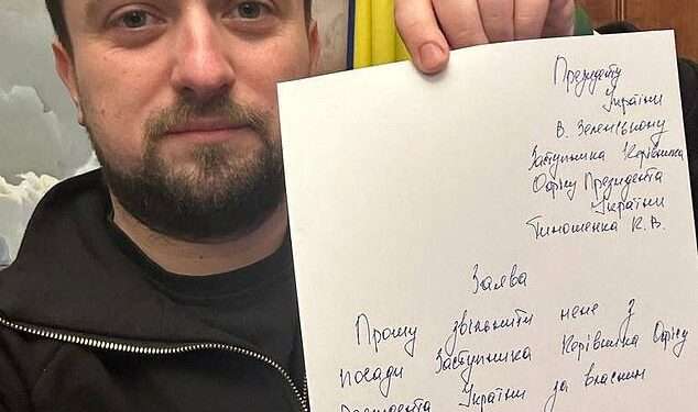 Kyrylo Tymoshenko holds up a note as he tenders his resignation, asking President Volodymyr Zelenskyy to relieve him of his duties, in this picture taken at an unknown location and released on social media on Jan. 24, 2023