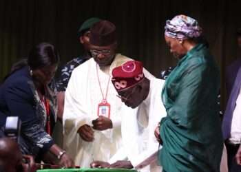 President-elect Bola Tinubu (C) signs papers during the presentation of the certificate of return to the President-elect by the Independent National Electoral Commission (INEC) in Abuja on March 1, 2023.