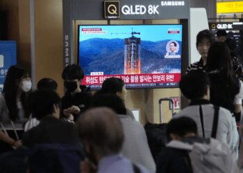 A TV screen shows a file image of North Korea's rocket launch during a news program at the Seoul Railway Station in Seoul, South Korea, Wednesday, May 31, 2023.