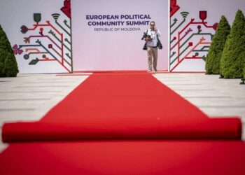 A man stands by banners during preparations at the Castel Mimi in Bulboaca, Moldova, Wednesday, May 31, 2023.
