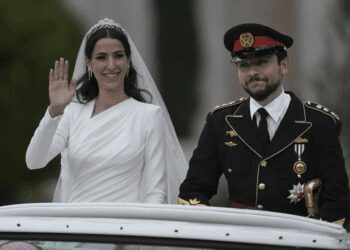 Jordan's Crown Prince Hussein and Saudi Rajwa Alseif wave to well-wishers during their wedding ceremonies in Amman, Jordan, Thursday, June 1, 2023.