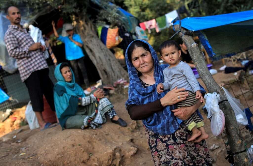 Migrants from Afghanistan are seen at a makeshift camp for refugees and migrants on the island of Samos Greece