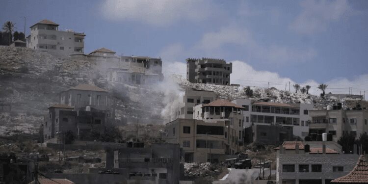 Smoke rises from fighting between Israeli forces and Palestinian militants in the West Bank city of Jenin Monday, June 19, 2023.