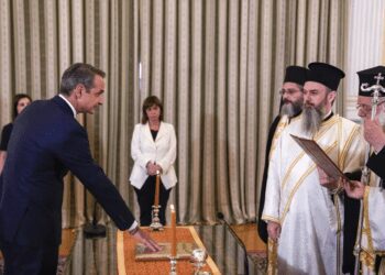 Greece's Prime Minister Kyriakos Mitsotakis, left, takes the oath during a swearing in ceremony at the Presidential palace, in Athens, Greece, Monday, June 26, 2023.