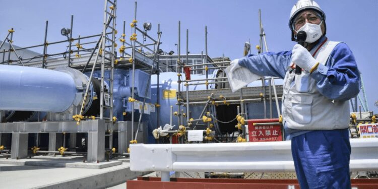 An employee of Tokyo Electric Power Company explains to the media about the facility to be used to release treated radioactive water at Fukushima Daiichi nuclear power plant in Fukushima, northern Japan, on June 26, 2023.