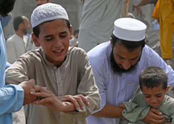 Boys weep over the death of a family member at a funeral a day after bomb blast in the Bajaur district of Pakistan's Khyber-Pakhtunkhwa province targeted a political rally, July 31, 2023.