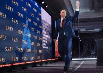 Republican presidential candidate Florida Gov. Ron DeSantis, right, waves as he leaves the stage after speaking to the Christians United For Israel (CUFI) Summit on Monday, July 17, 2023.