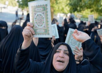 Iraqis raise copies of the Quran, Muslims' holy book, during a protest in Baghdad, Iraq, Saturday, July 22, 2023.