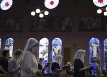 People attend an early morning Mass at the Urakami Cathedral on the 78th anniversary of the atomic bombing in Nagasaki, southern Japan, Wednesday, Aug. 9, 2023.