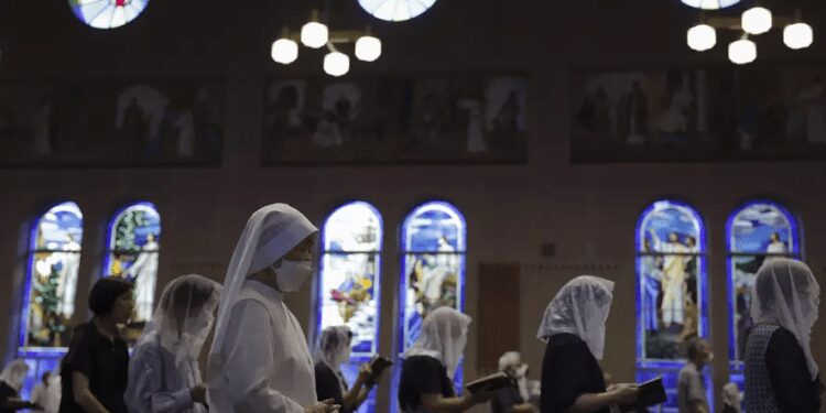 People attend an early morning Mass at the Urakami Cathedral on the 78th anniversary of the atomic bombing in Nagasaki, southern Japan, Wednesday, Aug. 9, 2023.