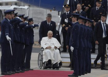 Pope Francis is welcomed by the honor guard as he arrives at the Figo Maduro airbase in Lisbon, Wednesday, Aug. 2, 2023.