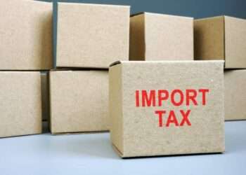 Import tax red stamp on cardboard box.