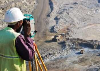 A locally employed surveyor at an open-pit mine.
