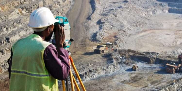 A locally employed surveyor at an open-pit mine.