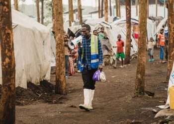 A community health worker walks through an IDP camp in North Kivu in eastern Democratic Republic of the Congo.