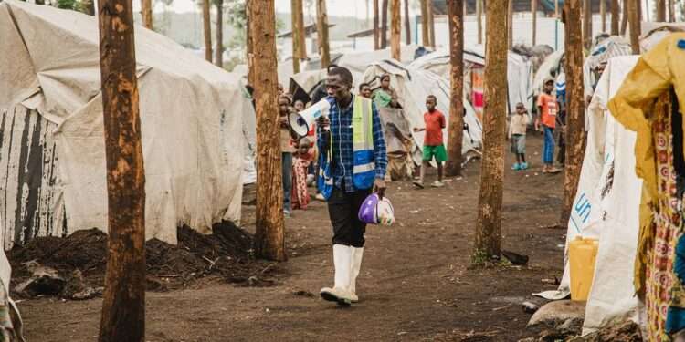A community health worker walks through an IDP camp in North Kivu in eastern Democratic Republic of the Congo.