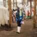 A community health worker walks through an IDP camp in North Kivu in eastern Democratic Republic of the Congo.