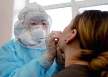 A woman is tested for COVID-19