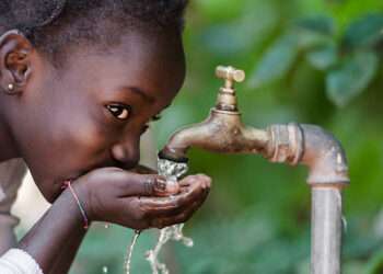 Clean Fresh Water Scarcity Symbol: Black Girl Drinking from Tap.
