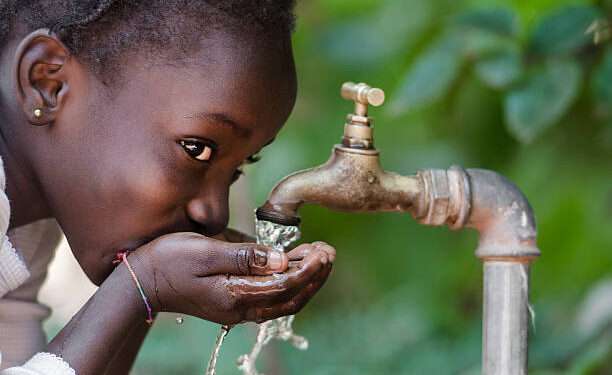 Clean Fresh Water Scarcity Symbol: Black Girl Drinking from Tap.