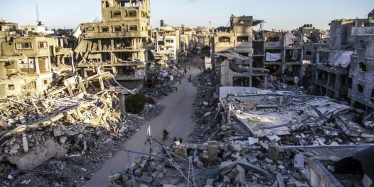 Humanitarian Tragedy Decried On War Anniversary 1 Palestinians are seen on a street between buildings destroyed in Israeli strikes in the northern Gaza Strip city of Jabalia, on Oct. 6, 2024.