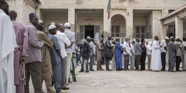 People line up to cast their ballot for legislative elections in Dakar, Senegal, Sunday, Nov. 17, 2024.