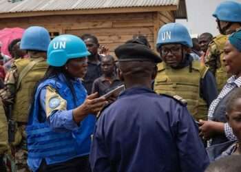 UN police officers talk to displaced people in a camp close to eastern Democratic Republic of the Congo provincial capital Goma.
