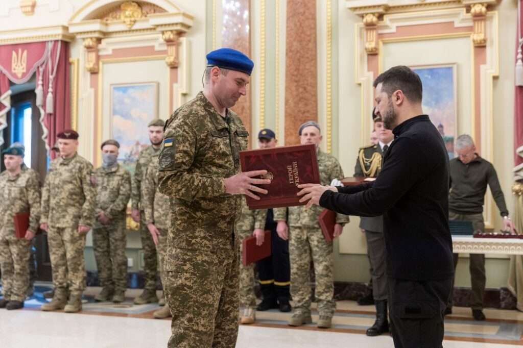 President Volodymyr Zelenskyy awards a soldier on the eve of the third anniversary of the full-scale Russian invasion.