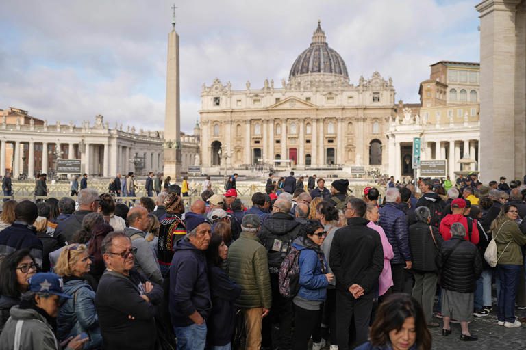 People wait in St Peter’s Square to pay their respects to the late Pope Francis