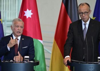 German Chancellor Friedrich Merz (R) and Jordan's King Abdullah II address a press conference at the Chancellery in Berlin on July 29, 2025.