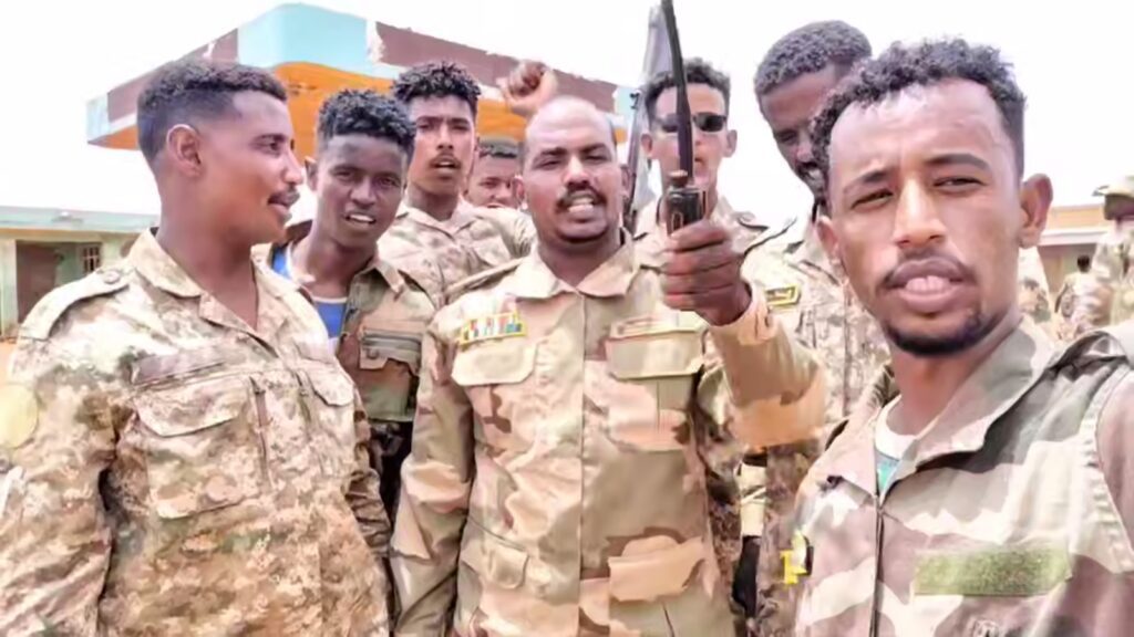 commander of the Sudan Shield Forces gestures as he stands with his fighters near the site of a deadly drone attack in Tumbul Sudan August 13 2025