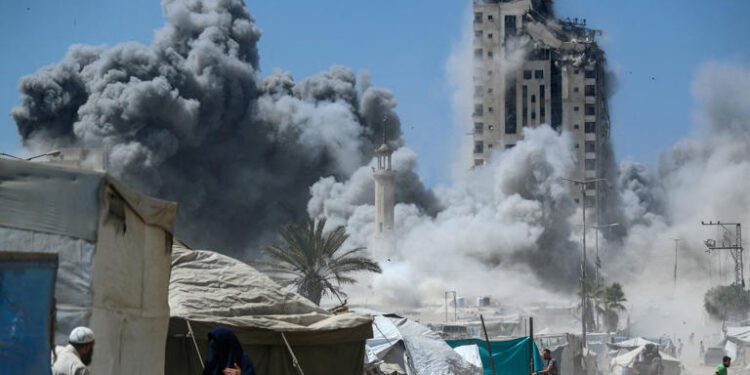 A man runs as smoke rises after a building is hit by an Israeli air strike, in Gaza City on Friday, September 5.