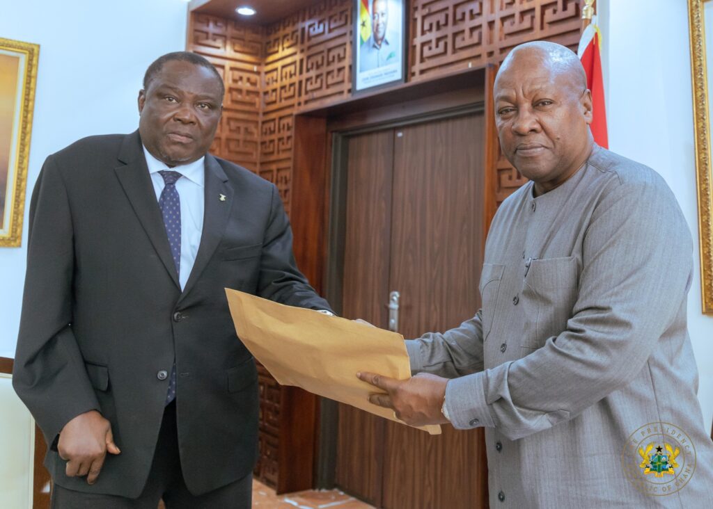 President Mahama receiving the Committee's report from Justice Gabriel Pwamang Scot