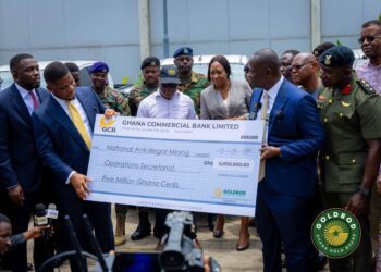 Goldbod CEO Sammy Gyamfi handingovier the GHS 5 million to Lands Minister Emmanuel Armah Kofi Buah