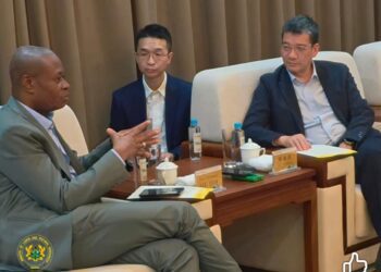 Deputy Lands Minister with Zinjin Staff