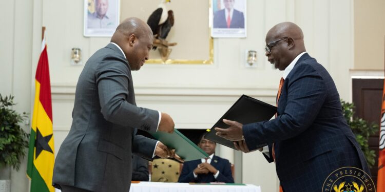 Ghana's Foreign Affairs Minister and Zambian Counterpart exchanging agreement after signing