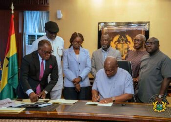 President John Dramani Mahama signing the five Bills as passed by Parliament
