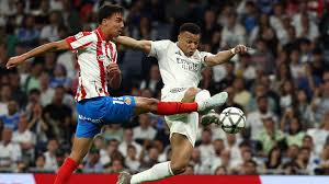 Kylian Mbappe battles for the ball