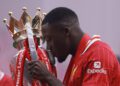 Ibrahima Konaté kisses the Premier League trophy