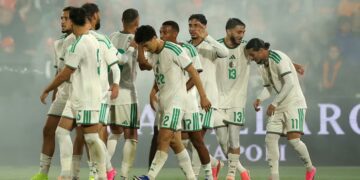 Players of the Desert Foxes celebrate with Hadj Moussa after he scored the winning goal against the Netherlands in Rotherdam