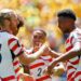 Alex Freeman congratulated by his teammates after scoring his first World Cup goal