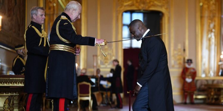 King Charles III knighting Idris Elba