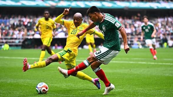 Mexico Beat South Africa in World Cup Opener Amid Three Red Cards 1 Bafana Bafana defender Madau attempts to block a cross from Mexican winger Roberto Alvarado
