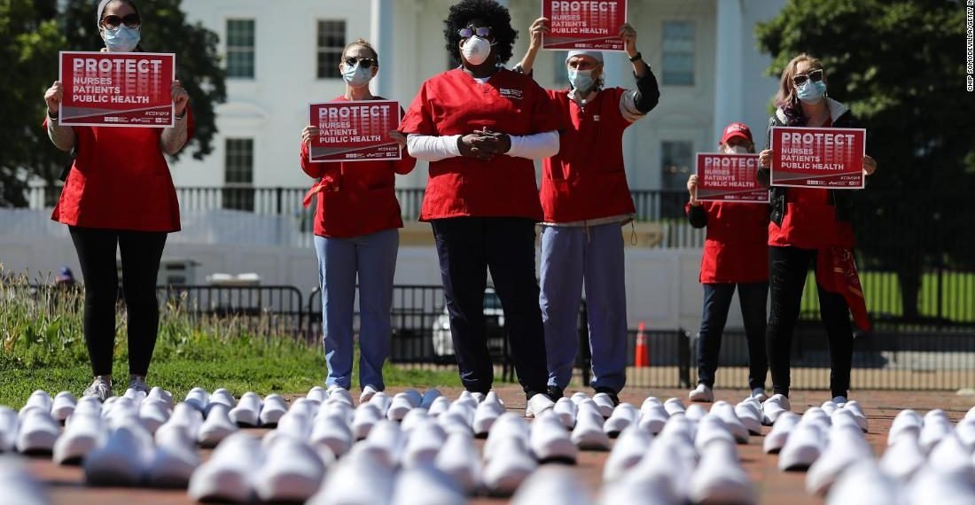 National Nurses United (NNU) display 164 white clogs shoes outside the US Capitol to honor the more than 160 nurses who have lost their lives from COVID-19 in the United States, and to demand the Senate act swiftly to protect nurses on the frontlines in Washington, DC on July 21, 2020. Photo by Olivier DOULIERY / AFP